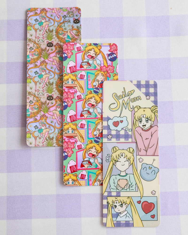 Set of colorful bookmarks with character designs on a purple checkered background