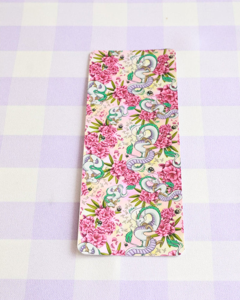 Floral and dragon patterned phone case on a checkered background