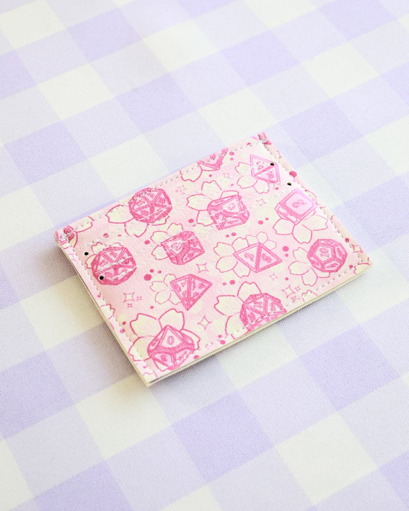 Pink notebook with floral pattern on a checkered background