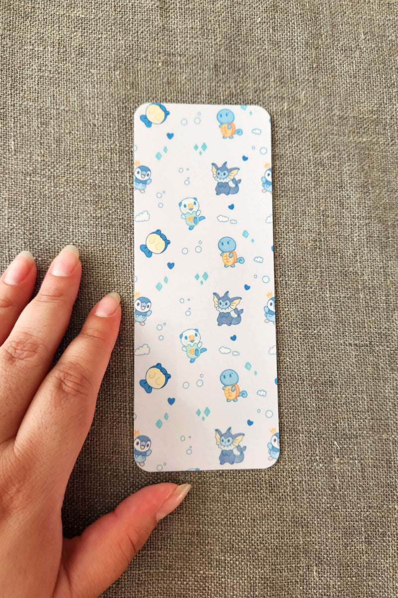 Phone case with cartoon character pattern held by a hand on a textured fabric background