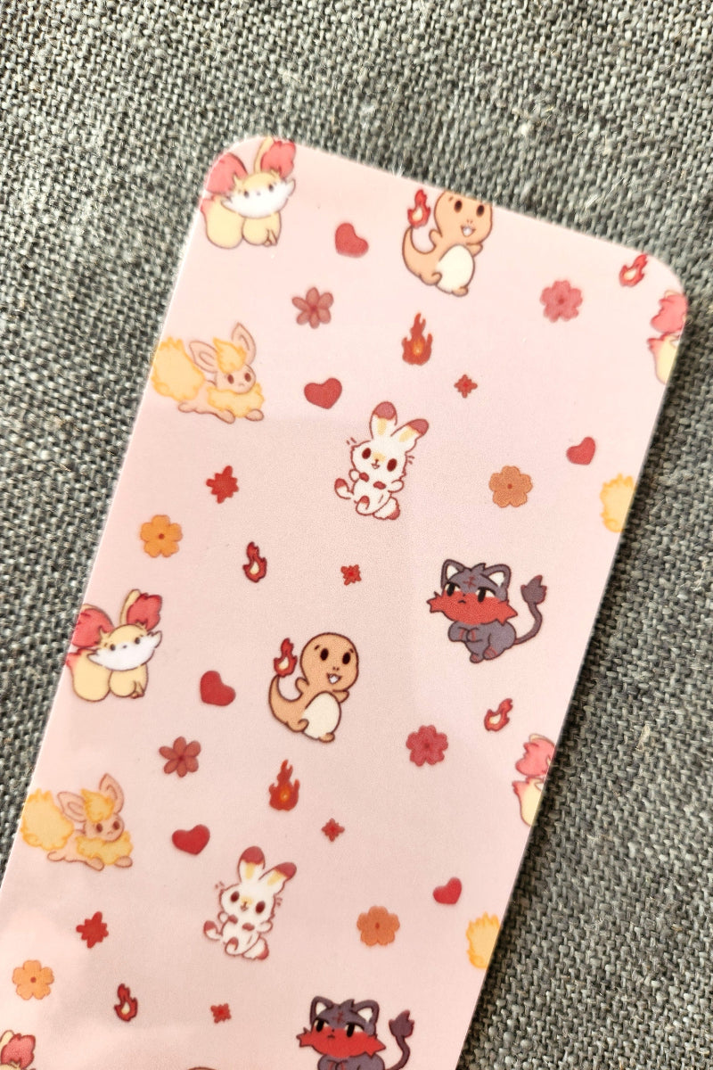 Pink phone case with cartoon animal designs on a textured gray background