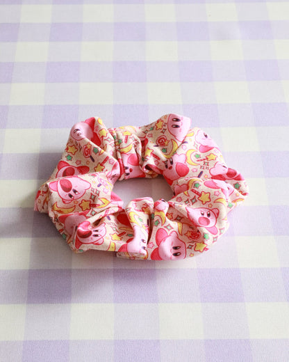 Floral scrunchie with pig designs on a checkered background