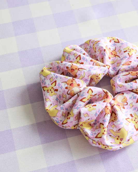 Scrunchie with cartoon character design on a checkered background