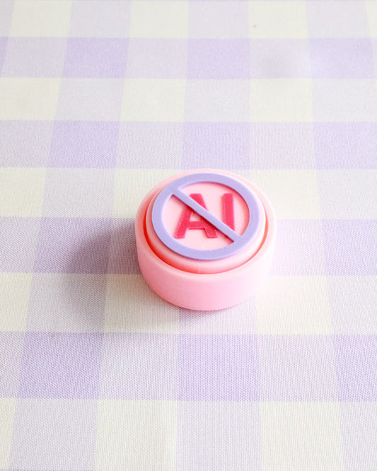 Pink button with a red circle and line symbol on a checkered background