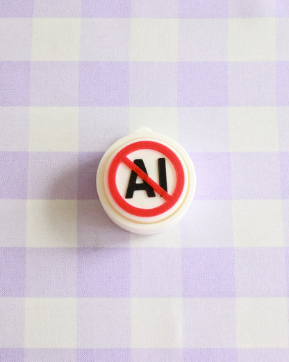 No AI symbol on a round object against a checkered background