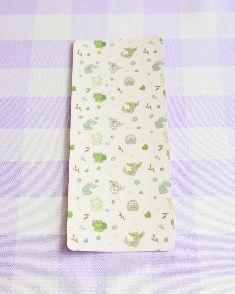 Notebook with green plant pattern on a purple checkered background