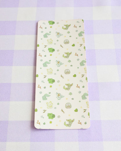 Notebook with green plant pattern on a purple checkered background