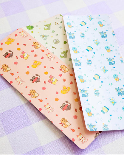 Two sheets of patterned paper with cartoon designs on a checkered background