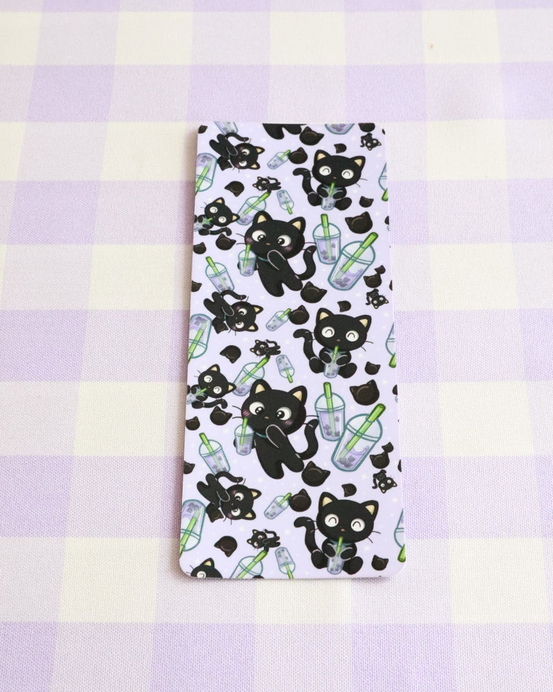 Notebook with black cat and bottle pattern on a purple and yellow checkered background