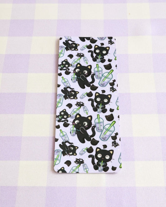 Notebook with black cat and bottle pattern on a purple and yellow checkered background