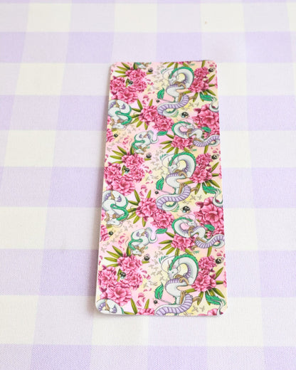 Floral and dragon patterned phone case on a checkered background