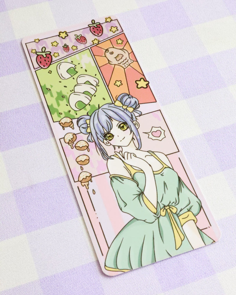 Cartoon character in a green dress with colorful illustrations on a checkered background