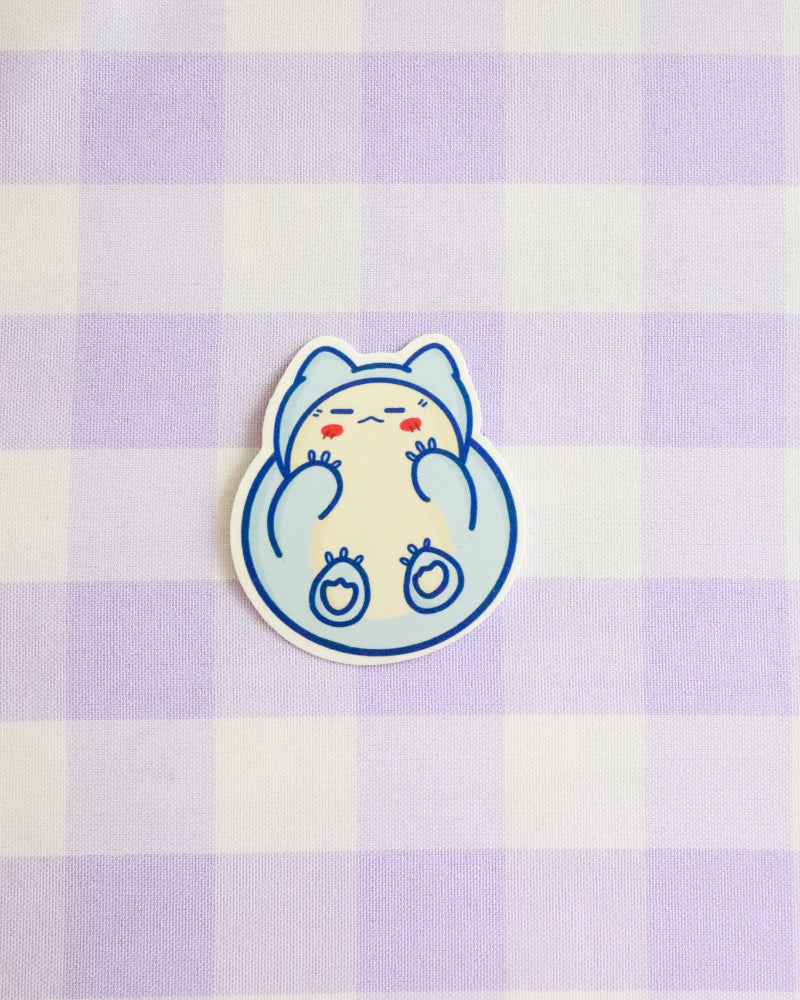 Cartoon cat sticker on a purple and white checkered background