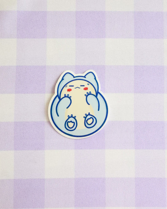 Cartoon cat sticker on a purple and white checkered background