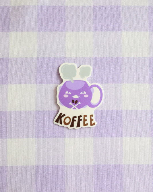 Sticker of a purple coffee mug with a face on a purple and white checkered background