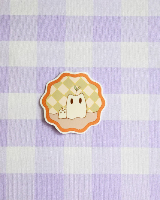 Sticker with a cartoon character on a purple and white checkered background