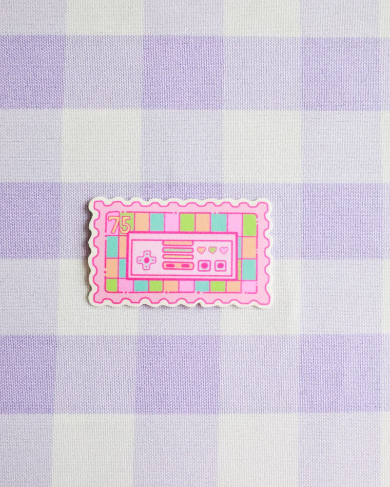 Pink cassette tape sticker on a purple and white checkered background