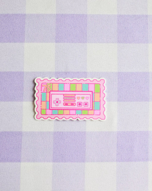 Pink cassette tape sticker on a purple and white checkered background