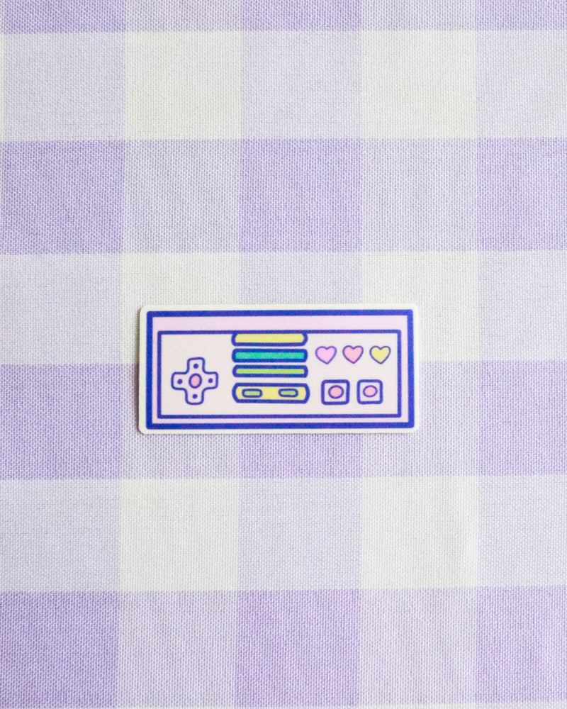 Checkered fabric with a retro gaming console patch on a light purple and white checkered background