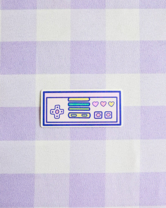 Checkered fabric with a retro gaming console patch on a light purple and white checkered background