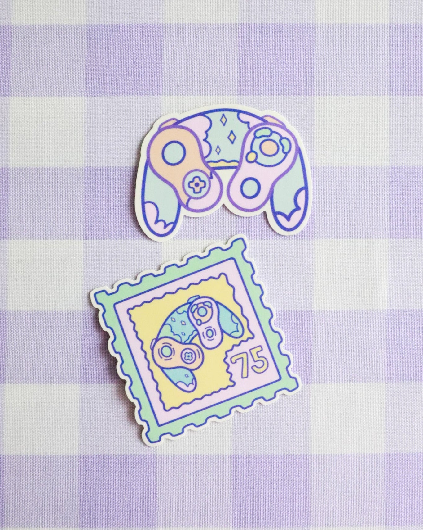 Two colorful stickers on a purple and white checkered background