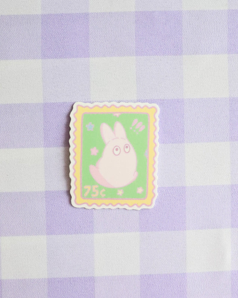 Cartoon character on a postage stamp design against a purple and white checkered background