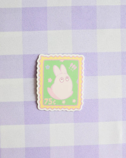 Cartoon character on a postage stamp design against a purple and white checkered background