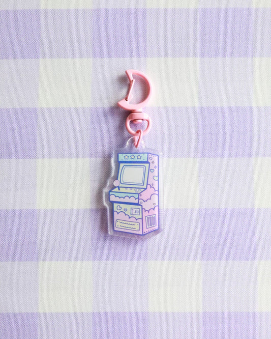 Pastel-colored arcade machine charm on a checkered fabric background