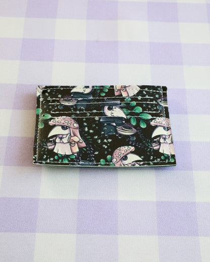 Cardholder with cartoon character design on a purple and white checkered background