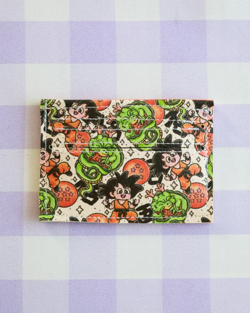 Cardholder with character design on a purple and white checkered background