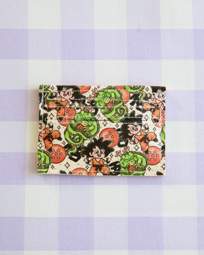 Colorful wallet with character design on a purple and white checkered background