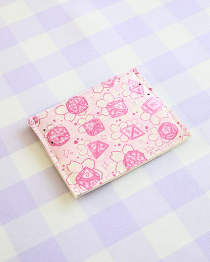 Pink notebook with floral pattern on a checkered background