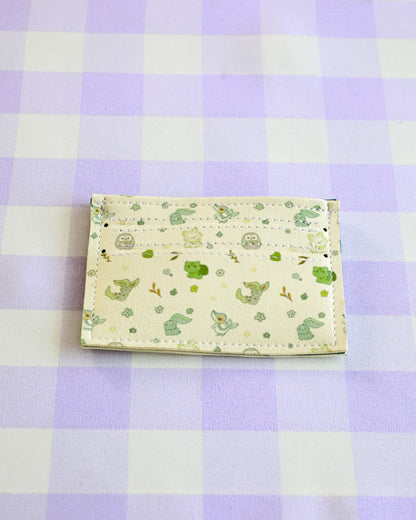 Small pouch with green pattern on a purple and white checkered background