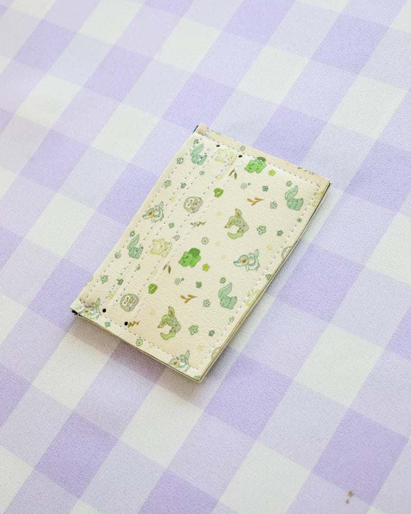 Notebook with a green pattern on a purple and white checkered background