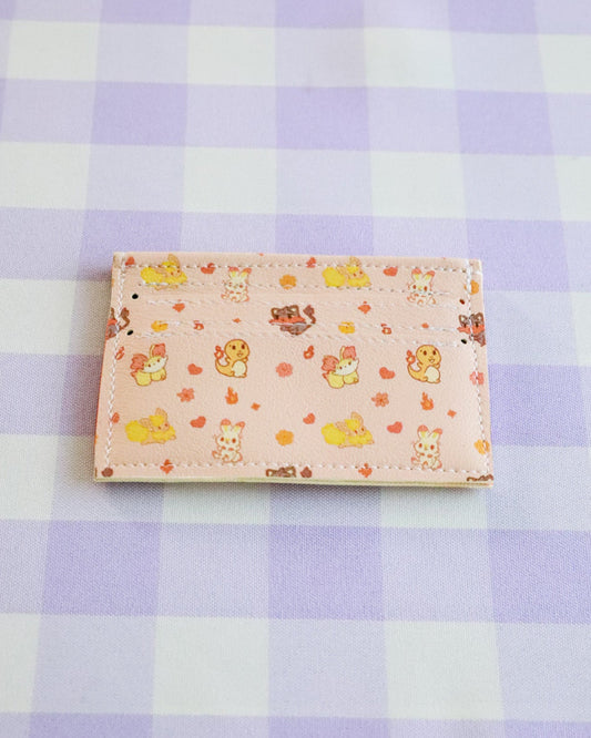 Small rectangular fabric sample with cartoon designs on a purple checkered background