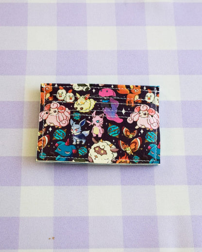 Colorful cardholder with cartoon characters on a purple and white checkered background