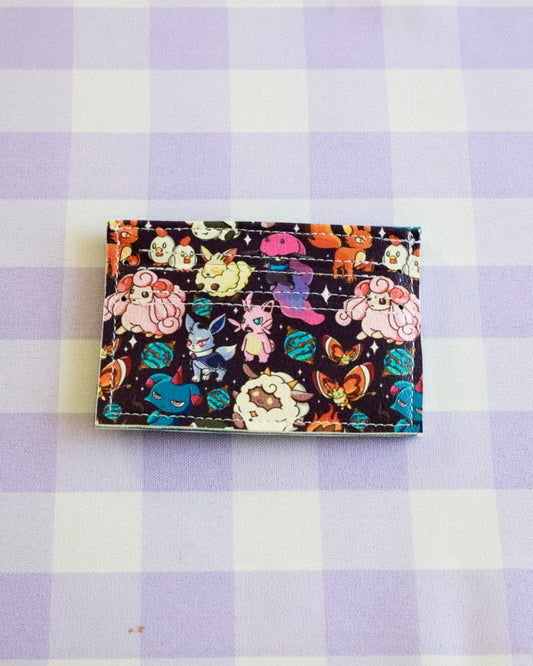 Colorful cardholder with cartoon characters on a purple and white checkered background