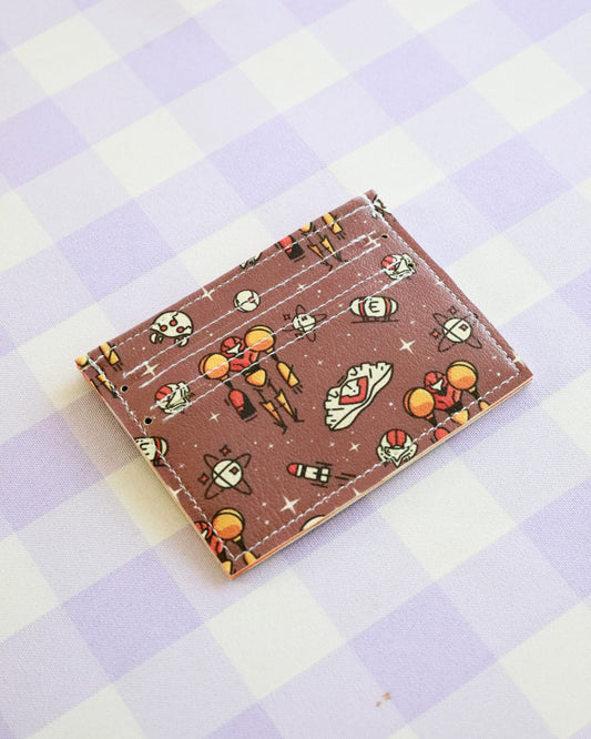 Cardholder with space-themed design on a checkered background