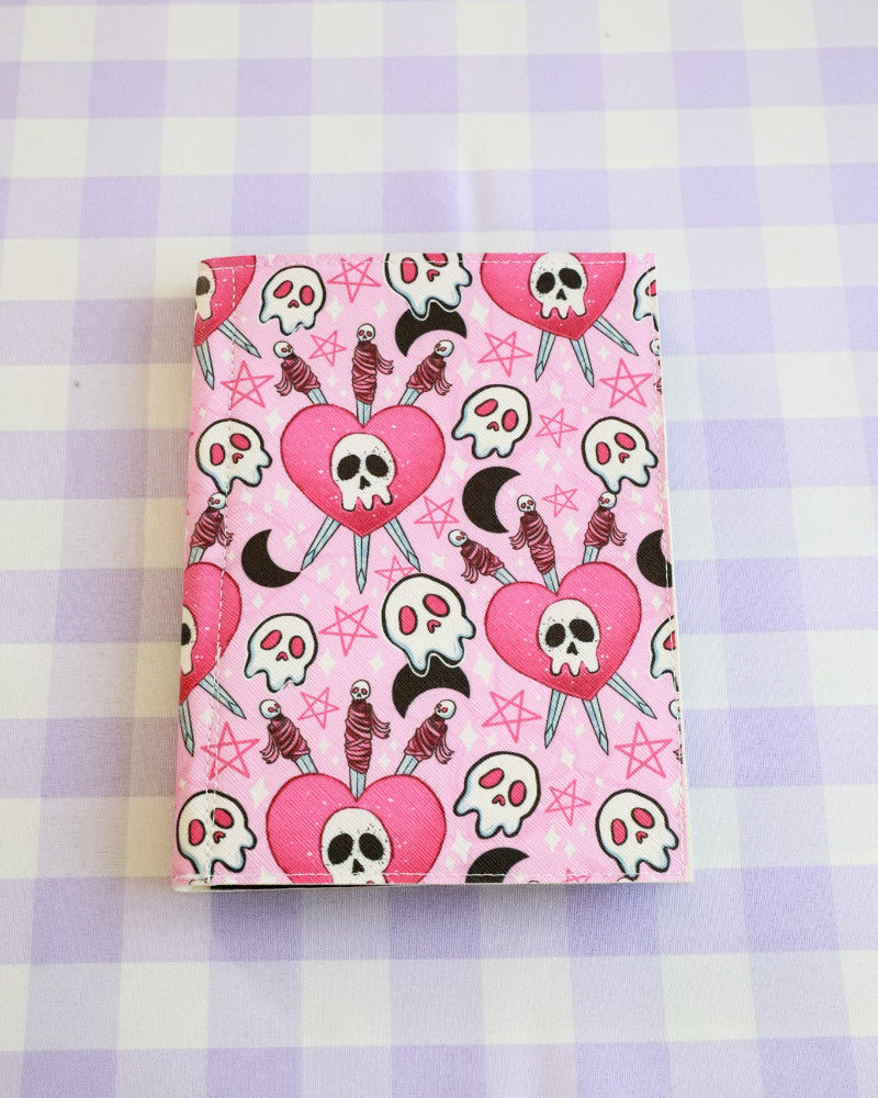 Notebook with skull and heart design on a checkered background