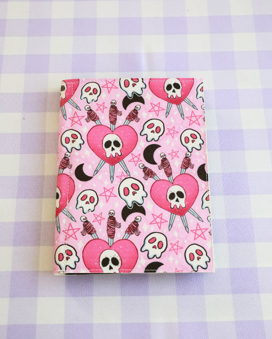 Notebook with skull and heart design on a checkered background