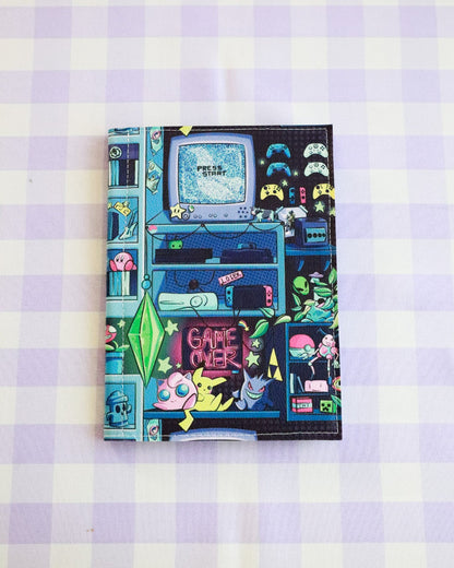 Notebook with retro gaming design on a checkered background