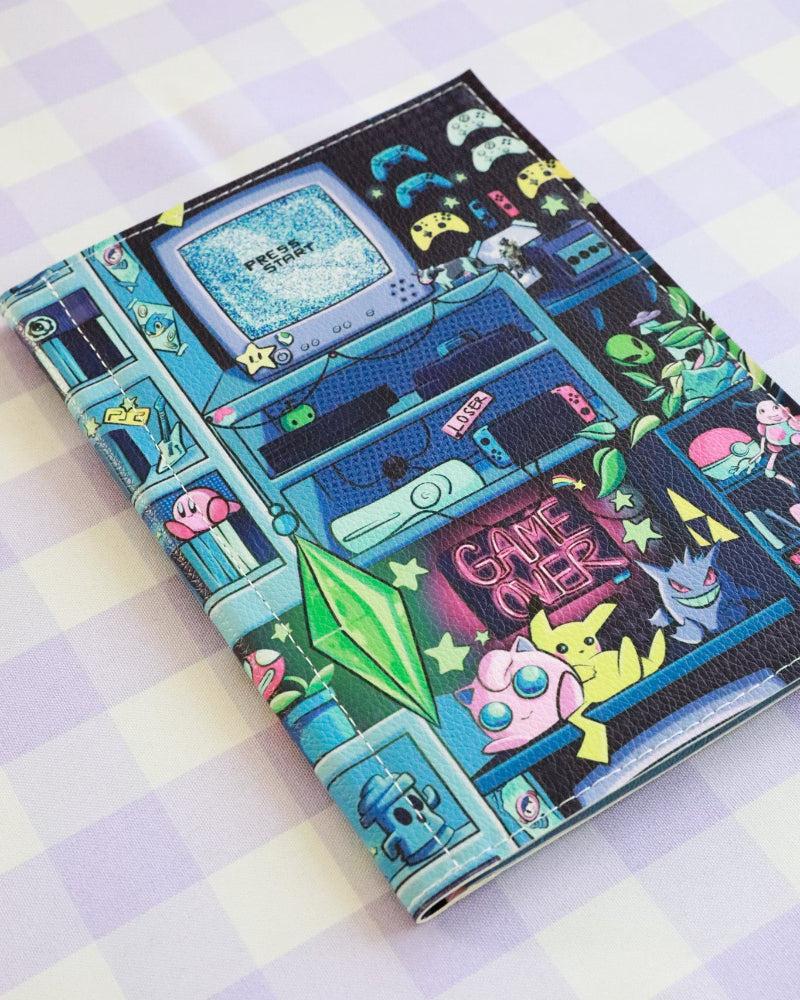 Notebook with retro gaming design on a checkered background