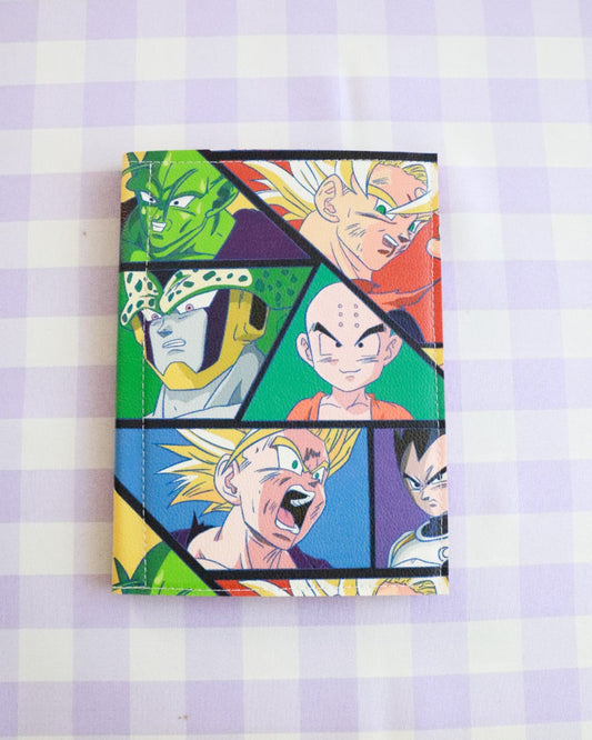 Notebook with colorful character illustrations on a purple and white checkered background