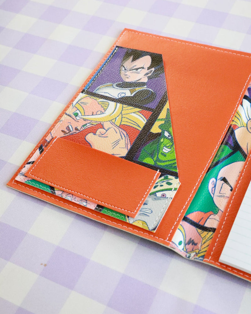 Card holder with anime character designs on a checkered background