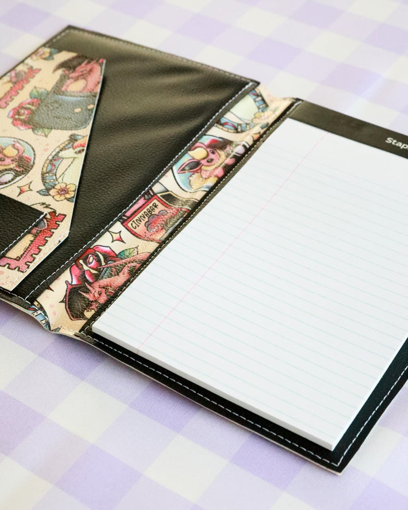 Notebook with colorful interior pages on a checkered fabric background