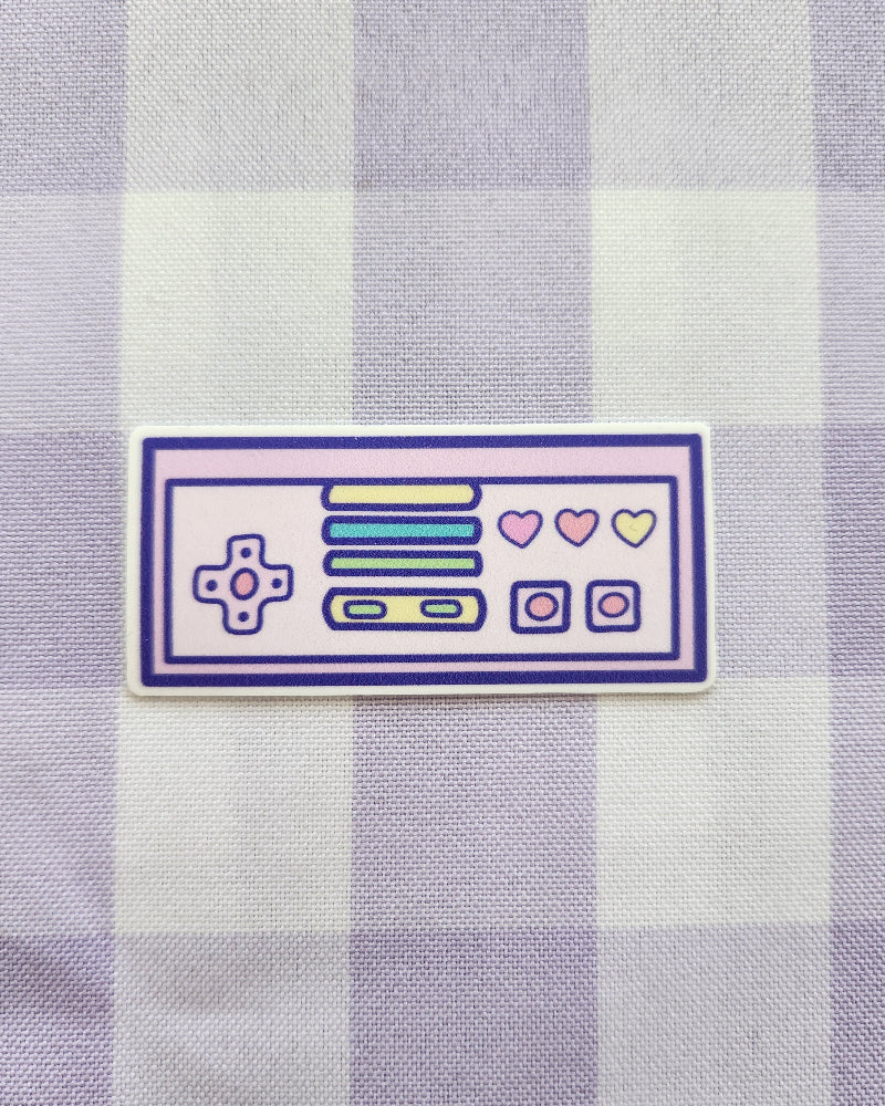 Sticker of a retro-style control panel on a purple and white checkered fabric background