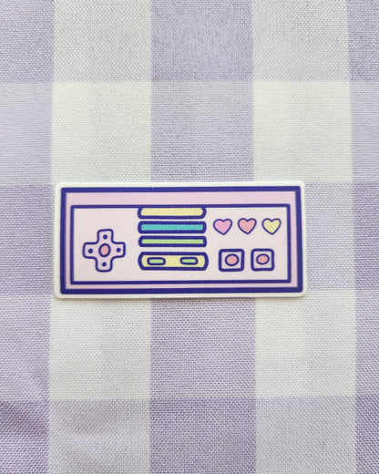 Sticker of a retro-style control panel on a purple and white checkered fabric background