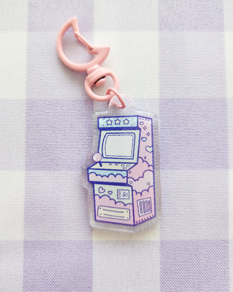 Keychain with arcade machine design on a striped background