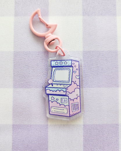 Keychain with arcade machine design on a striped background