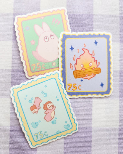 Three cartoon-themed postage stamps on a checkered background